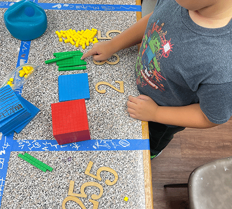 Kids using manipulatives during Math Adventures math workshop at Clairmont Advanced